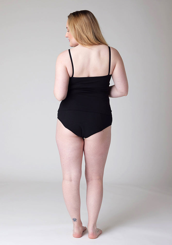 Back image of a five foot three, size 12 model wearing Ugly Pants' Black Overnight flow sleep set with a black cami top.