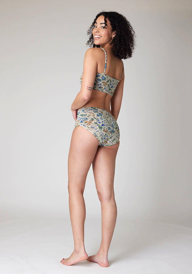 Back image of a five foot ten, size 10 model wearing Ugly Pants' Cream Floral Print Overnight flow sleep set with matching cream floral print crop top, featuring a self tie detachable bow.