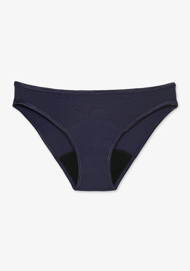 Bikini style women's underwear in Navy. It features a matching navy trim around the waistband and leg openings, with a black absorbent gusset area, suggesting it's designed for period protection or moisture control. The material appears to be soft, stretchy, and comfortable for everyday wear. The cut is classic and low-rise, combining a sleek, minimalist look with functional support.
