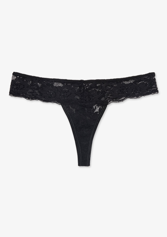 Black Lace Thong Underwear. The thong features a wide, floral lace waistband that adds a delicate and feminine touch. The front panel is also made of lace with a floral pattern, and the design tapers into a minimal back for a no-show effect under clothing. The style is sleek, elegant, and intended to be both stylish and discreet under form-fitting outfits.