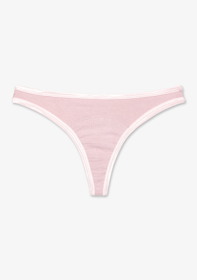 Image shows a blush pink thong-style period underwear laid flat on a white background. It features a minimalistic, low-rise cut with narrow sides and a slim front panel. The seams are cleanly stitched, and the waistband and leg openings are trimmed with light pink elastic for comfort and fit. An absorbent panel is subtly integrated into the crotch area, offering light menstrual protection while maintaining a discreet and sleek silhouette.