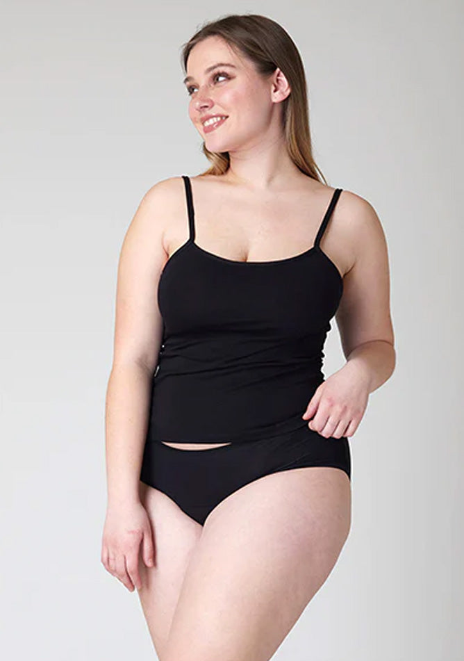 Close up image of a five-foot-five, size 14 model wearing Ugly Pants' Black Hipster Brief Period Pants in moderate to heavy absorbency, paired with a black cami top