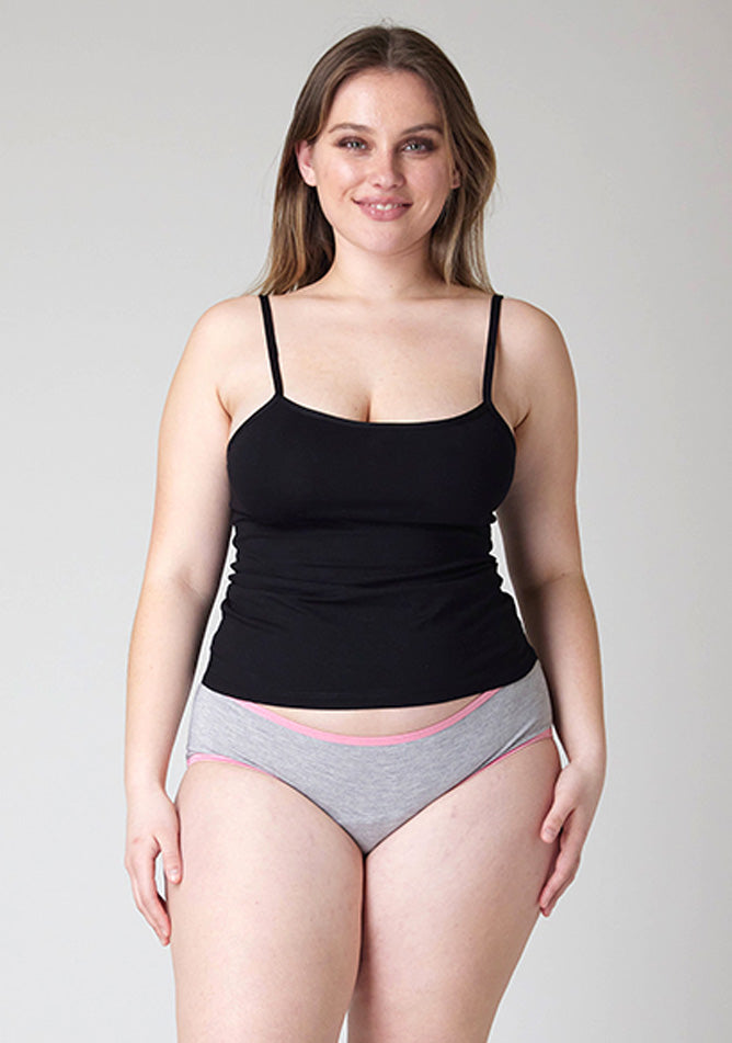 Close up image of a five-foot-five, size 14 model wearing Ugly Pants' Grey Hipster Brief Period Pants with light pink elastic in light to moderate  absorbency, paired with a black cami top