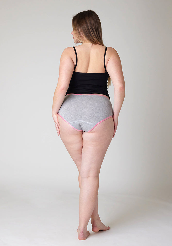 Back image of a five foot five, size 14 model wearing Ugly Pants' Grey Hipster Brief Period Pants with light pink elastic in moderate to heavy absorbency, paired with a black cami top