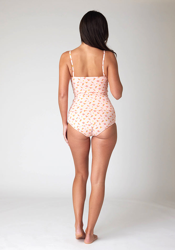 Back image of a five foot ten, size 10 model wearing Ugly Pants' Pink Floral Print Overnight flow sleep set with matching pink floral print cami