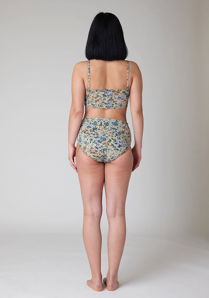 Back  image of a five foot six, size 8 model wearing Ugly Pants' Cream Floral Print Overnight flow sleep set with matching cream floral print crop top, featuring a self tie detachable bow.